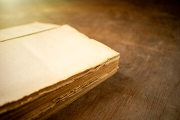 The leaves of an old book in the light of the sun. Vintage library. A dilapidated encyclopedia on a...