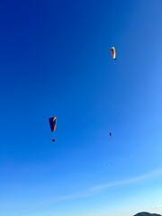 PHOTOGRAPH OF PARAGLIDERS FLYING FROM THE CHALCHIHUAPAN HILL, PUEBLA, MEXICO