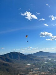 PHOTOGRAPH OF PARAGLIDERS FLYING FROM THE CHALCHIHUAPAN HILL, PUEBLA, MEXICO