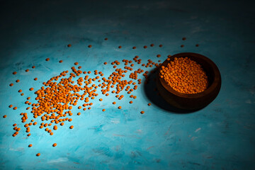 lentil cereals on blue background, pea family grains - obrazy, fototapety, plakaty