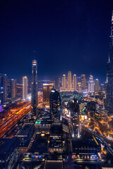 Modern downtown United Arab Emirates. Dubai night amazing skyline cityscape with illuminated skyscrapers, Aerial top view - obrazy, fototapety, plakaty