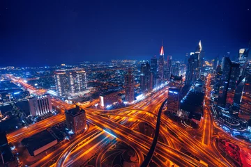 Foto op Canvas Aerial top view night cityscape of Dubai downtown skyscrapers with illuminated and highway. Business and financial modern district of city UAE © Parilov
