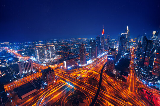 Fototapeta Aerial top view night cityscape of Dubai downtown skyscrapers with illuminated and highway. Business and financial modern district of city UAE