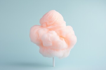 cloud like cotton candy dessert on stick on minimal light blue background with copy space left and right