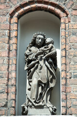 Fototapeta na wymiar Gdansk Old Town Gothic Church Exterior With A Religious Sculpture
