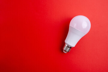 Paper and light bulb on a colored background. Idea and business concept. Place for text