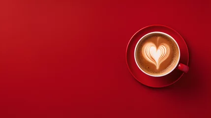 Fotobehang close up of red cup of cappuccino coffee on neat red background from above - foam forming a heart © Jakob