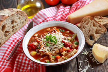 Minestrone soup with pasta and vegetables. Italian food. Selective focus.
