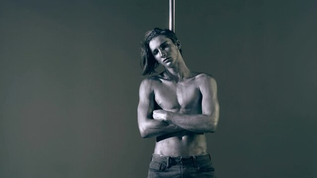 Flexible man exercises on pylon. Sexy flexible man demonstrates sexy flexible body. Flexibility stretching. Flexible female body. Pole dance. Male stripper. Strip dance, man pole dancing.