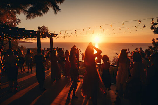 A crowd of people dancing and having fun at a beach party at sunset. Vacation concept. Generated by artificial intelligence