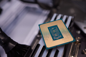 Cropped image of an engineer showing a computer microchip on the foreground