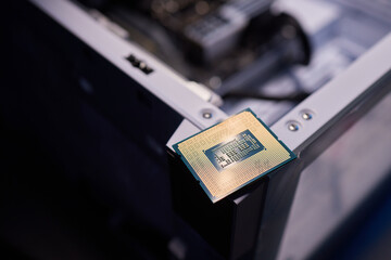 Cropped image of an engineer showing a computer microchip on the foreground