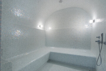 Classic Turkish bath - hamam, decorated with mosaic light blue tiles.