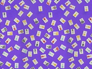 Plastic tiles from the game rummikub, rummicub or  okey in Turkey , scattered and arranged on  purple background