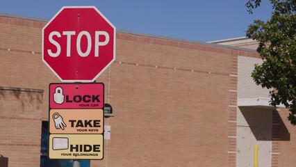 signs in a parking lot to lock your car