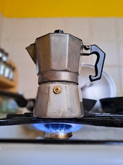The mocha coffee pot on the stove for Italian coffe. Gas stove, brewing coffee