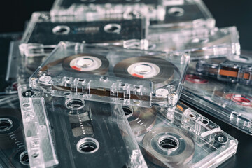 Fototapeta premium A stack of audio tape cassettes on black background. Retro vintage music concept.