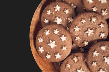 Delicious sweet cocoa cookies biscuits on a wooden plate . Overhead shot