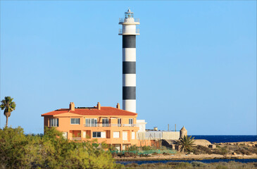 Fototapeta na wymiar Black and white horizontally striped lighthouse