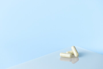 capsule, medicine tablet on a blue background