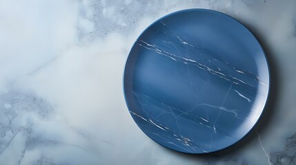 Top View of an empty Plate in navy blue Colors on a white Marble Background. Elegant Template with Copy Space