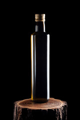 Olive oil round bottle on wood stump