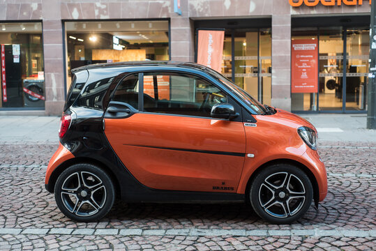 Strasbourg - France - 3 February 2024 - Profile view of orange and black smart car parked in the street
