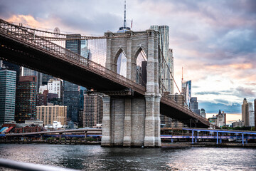 View of Brooklyn Bridge with Lower Manhattan skyline seen from the East River in New York City, United States.