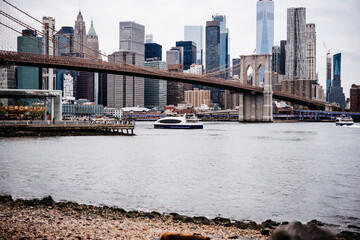 View of Brooklyn Bridge with Lower Manhattan skyline seen from the East River in New York City,...