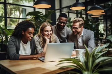 diverse business team at meeting at modern office looking at the screen of laptop, smiling and discussing project