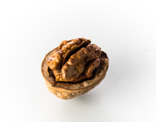 One half of a walnut on a white background