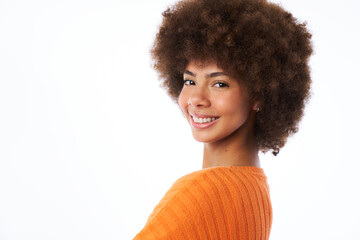 portrait of a latina woman with afro hair smiling looking at the camera