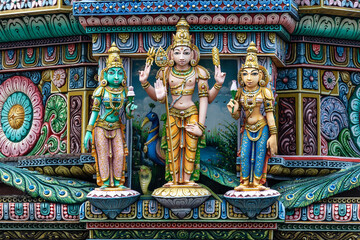 Fototapeta na wymiar Colored decorations and statues on the exterior of the Hindu Temple Sri Maha Mariamman Temple (