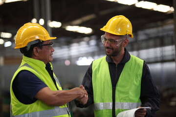 worker or engineer working in factory with safety uniform , safety hat and safety glasses , image is safety concept or happy workplace