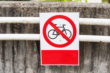 No bicycles warning sign. Traffic sign prohibiting bicycles from passing. A real photo of a road sign prohibiting cycling. No bicycles allowed sign on the walking path.