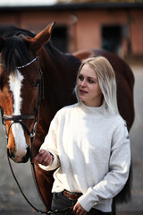 Horse head portraits with bridle and rider next to him.