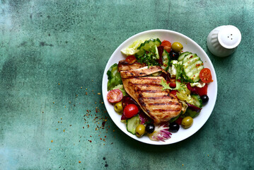 Grilled chicken fillet with fresh vegetable salad. Top view with copy space.