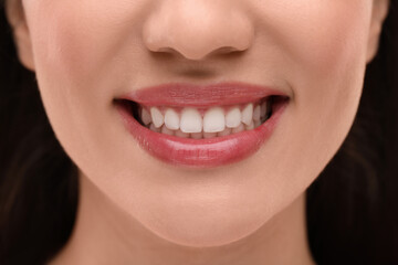 Woman with clean teeth smiling, closeup view