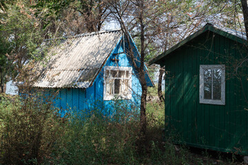 Colorful wooden tourist house among green trees