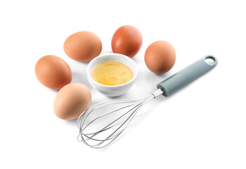 Whisk, whole and broken eggs isolated on white