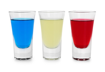 Different shooters in shot glasses isolated on white. Alcohol drink