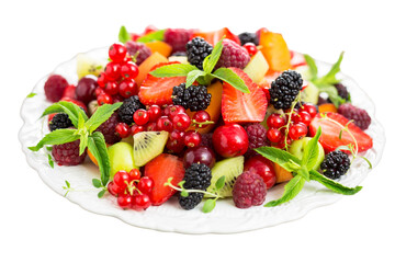 fruit salad on a plate isolated on a white background