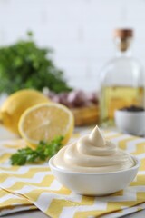 Tasty mayonnaise sauce in bowl on table. Space for text