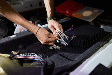 Technician installing the car audio processor Car audio installation concept.