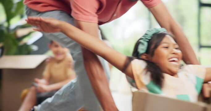 Box, moving and father playing with girl in new home for bonding, fun and quality time together. Happy, excited and young dad push child or kid in cardboard at modern apartment, house or property.