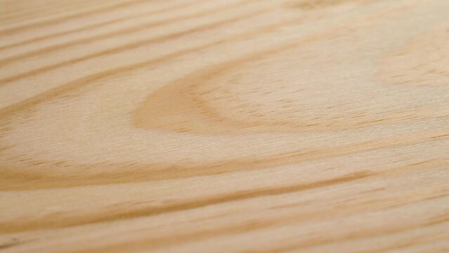 Rotating wood texture background close up. Natural pine board fibers