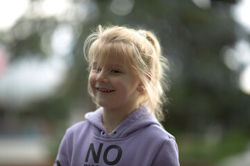 Innocence Revealed, A Vibrant Girl Radiates Joy in Her Amethyst Sweater