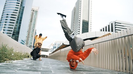 Young happy hipster perform break dancing or foot step with friend moving to hiphop music together....