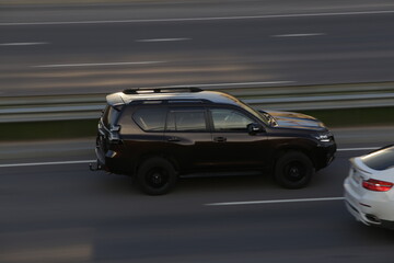 Black SUV with black rims driving on highway