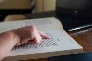 close up of hands of a person reading a book